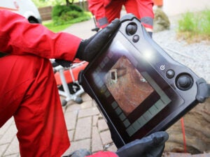 A plumber inspects sewer drain through video inspection in Jacksonville, FL