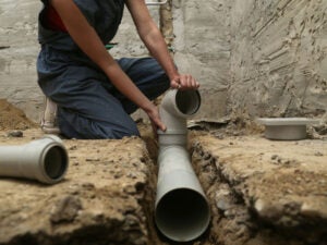 A plumber repairing a sewer pipeline in Jacksonville, FL