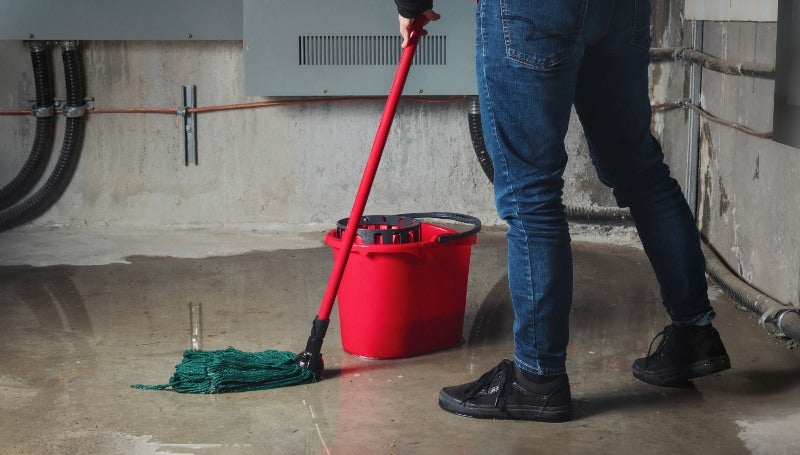 Basement flood cleanup with mop and bucket in Jacksonville, FL